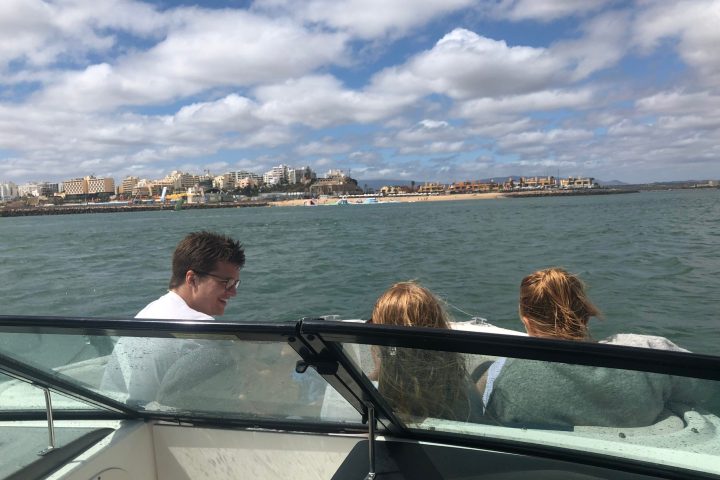 a man standing next to a body of water