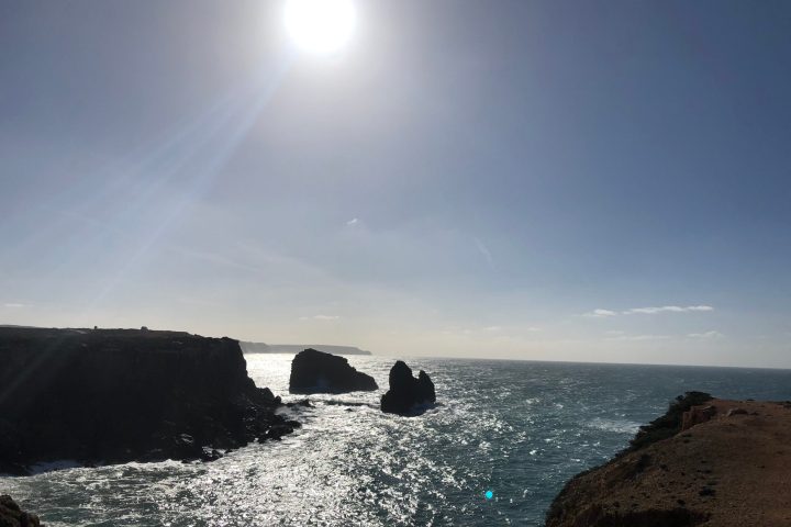 a body of water with a mountain in the ocean