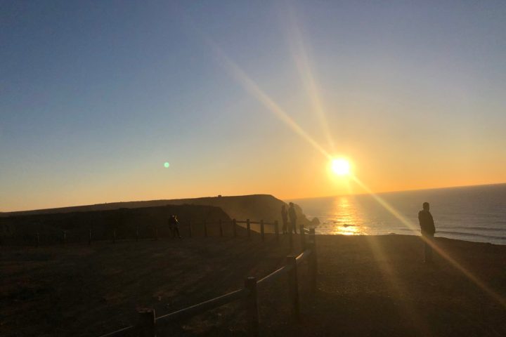 a rainbow over a city at night