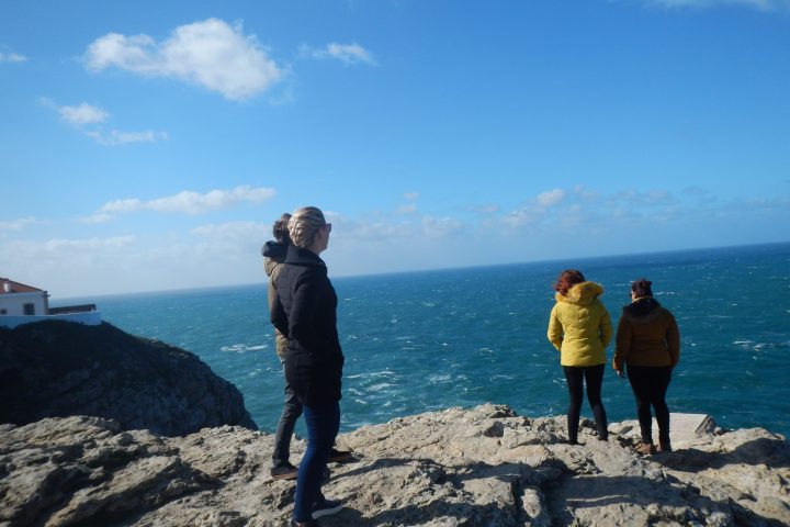a man and a woman standing on a rocky beach