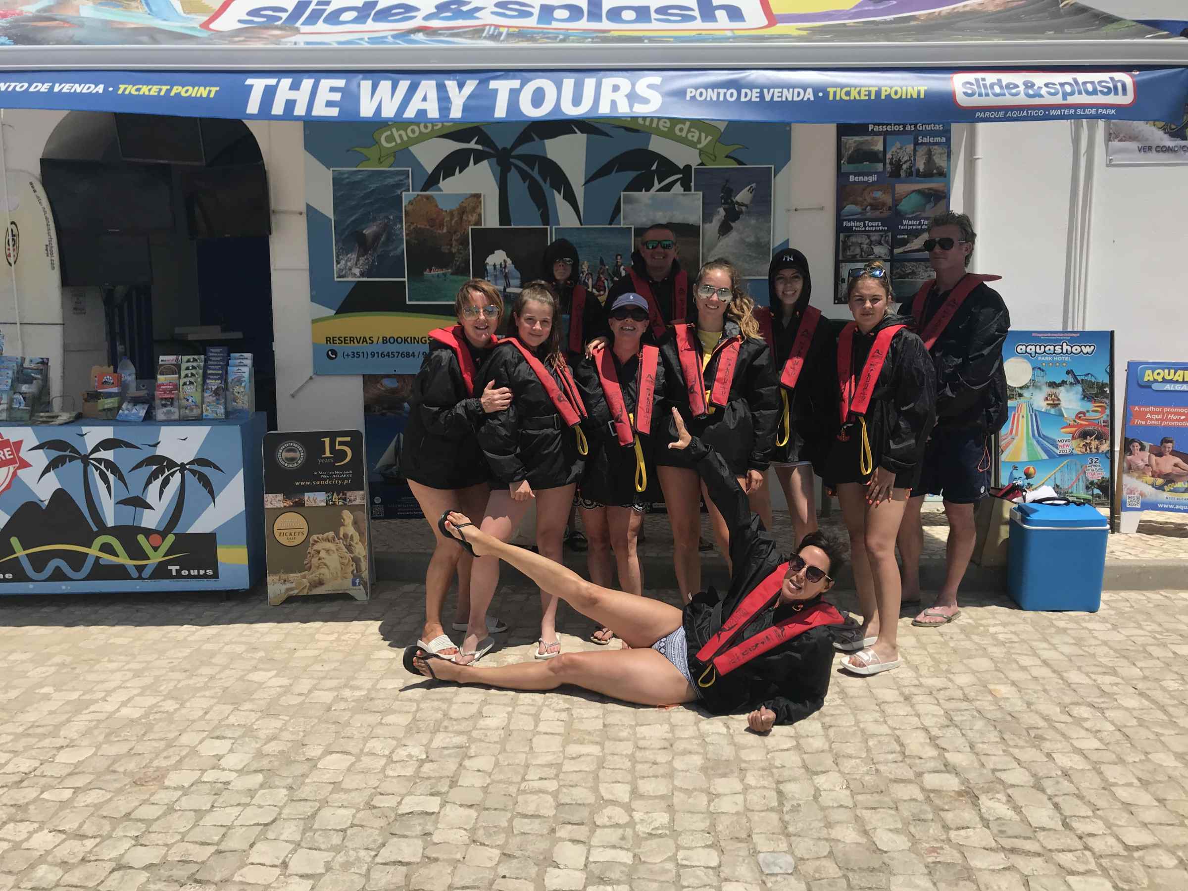 a group of people standing in front of the way tours building