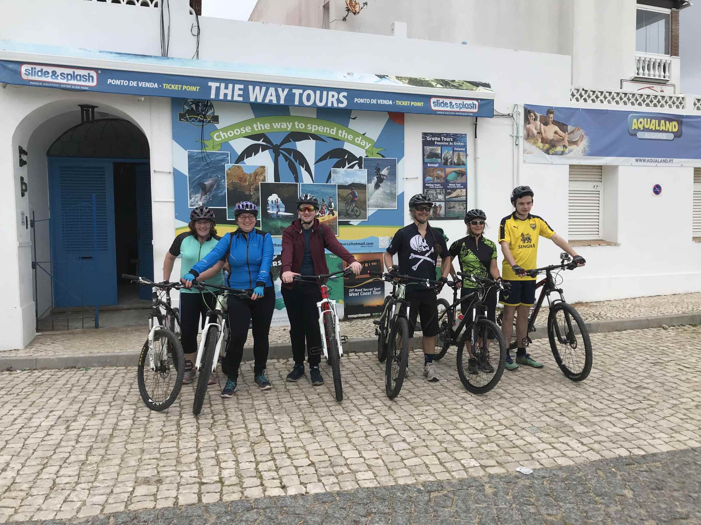 a group of people posing on bikes
