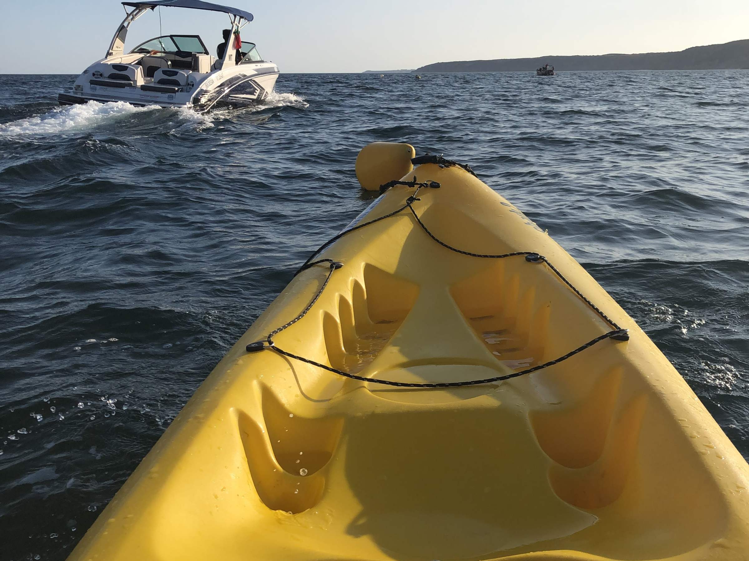 a yellow kayak sitting on top of a body of water
