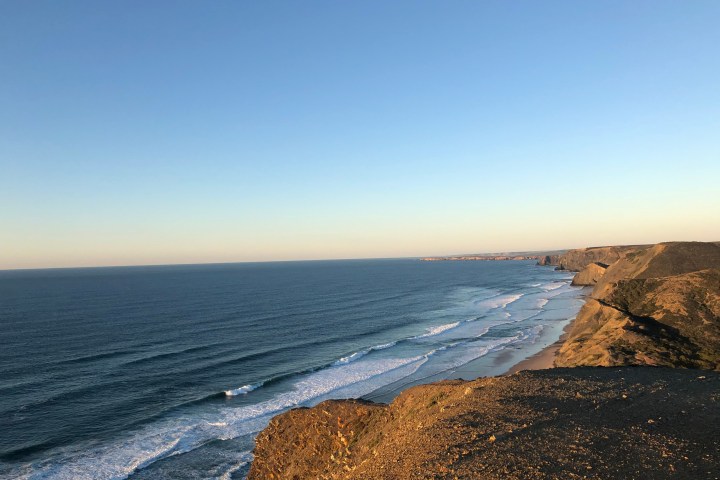 a rocky beach next to the ocean
