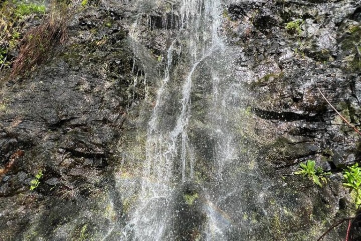 a large waterfall over some water