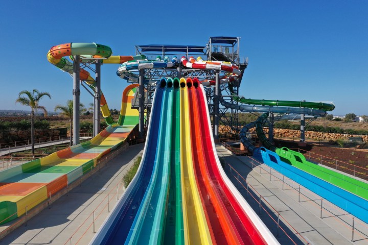 Colorful water slides at a water park on a clear day.