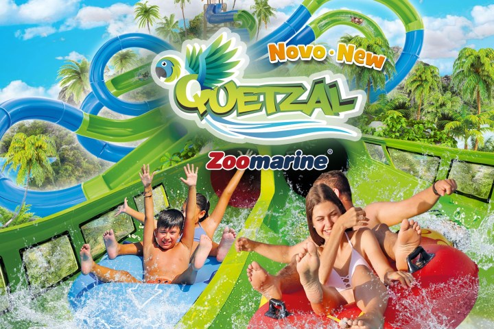 People enjoying water slides at Zoomarine Quetzal, surrounded by tropical trees and blue sky.